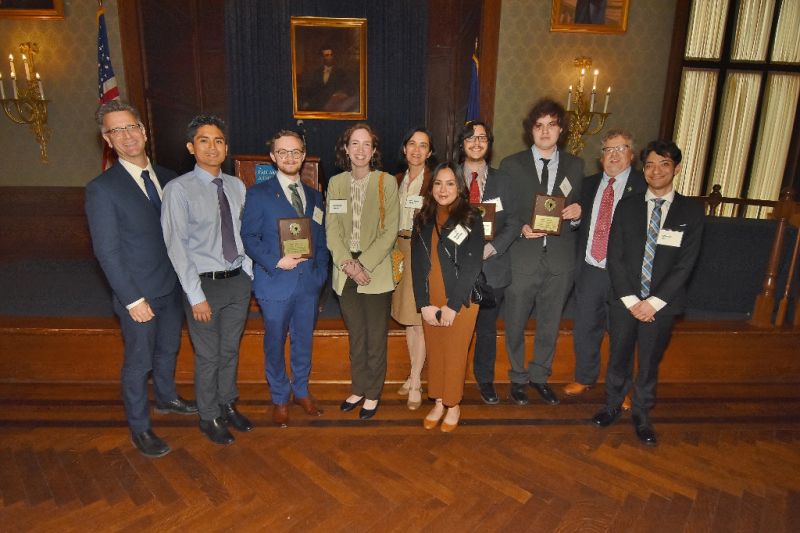 Large group of formally dressed attendees poses together during Pan American Day 2022 group photo.